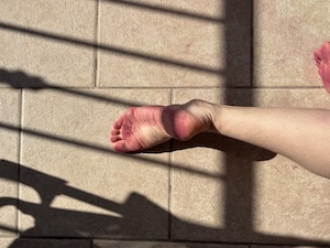 Dancing in my underpants. Picture from the photobook. A foot with a railing shadow over it